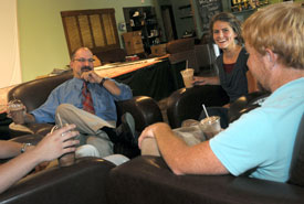 Scott Huelin (left), director of Union's Honors Community, visits with honors students Charlotte (Kline) Smith and Josh Smith, both 2011 graduates, in Barefoots Joe. (Photo by Morris Abernathy)