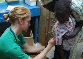 Jordan Hughey gives an injection to a child in Ghana.