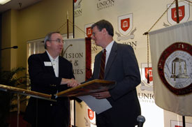 President Dockery presents Jackson with a framed certificate to induct him into the R.G. Lee Society of Fellows.