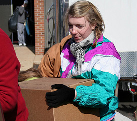 Sophomore Jewel Marshall helps a Watters resident load his recovered items into his truck to be taken home. (Photo by Kristi McMurry)