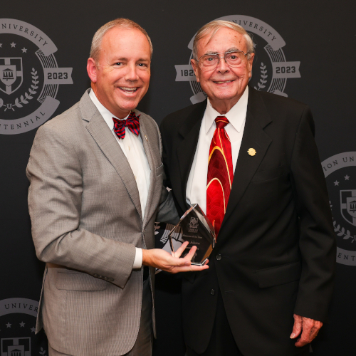 Union President Samuel W. "Dub" Oliver (left) presents the Alumnus of the Year Award to John Adams during the Nov. 4 Meritorious Service Awards banquet. (Photo by Suzanne Rhodes)