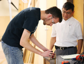 Senior engineering major Joshua Guthrie (left) works on a project as engineering professor Don Van observes. Guthrie was one of 11 engineering seniors who passed the Fundamentals of Engineering exam. (Photo by Kristi Woody)