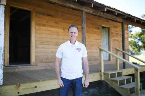 Ernest Easley stands outside the R.G. Lee birthplace that was recently moved to the Union campus. (Photo by Kristi Woody)