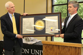 State Sen. Lowe Finney (right) presents a framed copy of a Tennessee legislature resolution recognizing Union's Phi Alpha Theta chapter to Stephen Carls, the chapter's adviser.