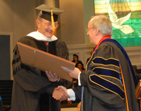 Union University President David S. Dockery presents an honorary Doctor of Humanities degree to Jim Moss. (Photo by Morris Abernathy)