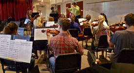 Members of the University Orchestra prepare for their upcoming Nov. 8 concert. (Photo by Kacee Enzor)