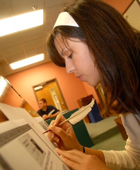 Union sophomore Katherine Kipp works on a manuscript quire as part of Gavin Richardson's Middle Ages class on Chaucer. (Photo by Morris Abernathy)