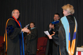 President David S. Dockery congratulates English professor Pam Sutton, who was named Faculty Member of the Year at the Awards Day chapel service May 10. (Photo by Morris Abernathy)