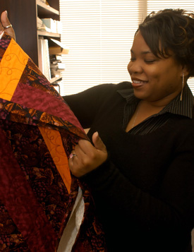 Kimberly Brown, of New Orleans, one of 11 students who transferred to Union in the fall because of Hurricane Katrina, selects a quilt. (Photo by Morris Abernathy)
