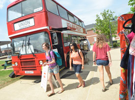 Union students walk by the Red Bus Project on the campus April 3. (Photo by Morris Abernathy)