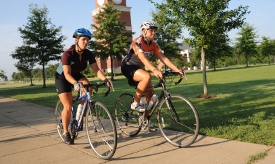 Union junior Bethany Stallings (left) and May graduate Erin Morris ride across campus during their recent stay at Union as part of the cross-country Ride:Well Tour. (Photo by Morris Abernathy)