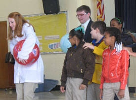 Union chemistry students Brooklin Byrd (left) and Tyler Jones work with students from Alexander Elementary School on a science experiment. 