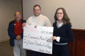 Target representatives Angel Melendez, left, and Scott Bauer, center, make a $1,500 donation to Community Music Center director Marya Bailey. (Photo by Morris Abernathy)
