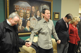 Tennessee Baptist Convention President Tom McCoy (center) prays with Union staff members during his visit to campus March 25. (Photo by Morris Abernathy)