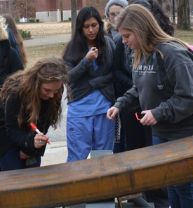Union students sign the steel beam that will be the highest piece of structural steel in the new library. (Photo by Morris Abernathy)