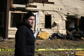 Junior Rose Rogers tries to remember moments from when the tornado devastated campus. Behind her is what remains of her dorm where she was located during the hit. Photo by Stephanie Schroeder