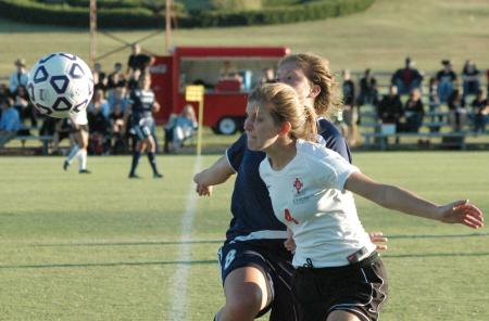 Emily Rawls blocks off a defender as she works for possession of the ball in Union's 2-0 win over Lambuth. - Photo by Tommy Sadler