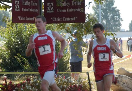 Zach Covington (left) and Joel Wellum race past Union street signs as fans watch along the way. - Photo by Steven Aldridge
