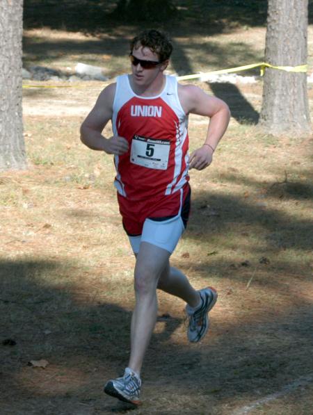 Grant Luke races through a shady spot during the Union University Cross Country Invitational. - Photo by Steven Aldridge