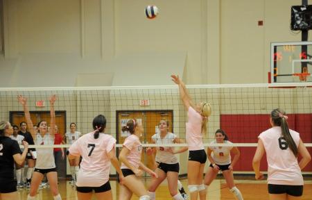 Katie Adams sets one of her teammates in Union's 3-0 win over Rhodes College. - Photo by Morris Abernathy