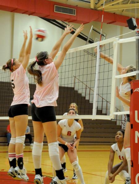 Ashley Young (left) and Emilie Ogas go up for a block attempt. - Photo by Morris Abernathy