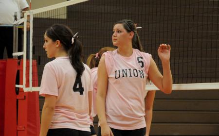 Emilie Ogas (4) and Lindsey Wilson (4) await the serve from their teammate. - Photo by Morris Abernathy