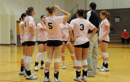 Coach Greams talks with his players during a timeout. - Photo by Morris Abernathy