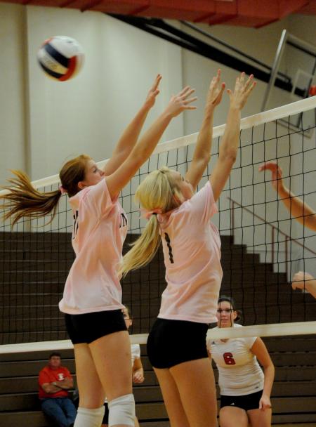 Anna Sims (left) and Katie Adams go up for the block in Union's 3-0 win over Rhodes College. - Photo by Morris Abernathy