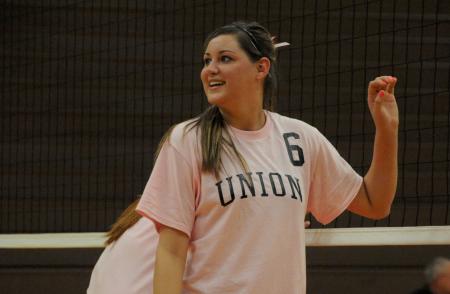 Senior hitter Emilie Ogas shows a smile as she waits for the serve. - Photo by Morris Abernathy
