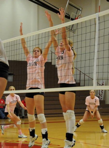 Anna Sims (left) and Amanda Hutchison Coyle (right) go up for the block during Dig Pink Night versus Rhodes (Tenn.) College. - Photo by Morris Abernathy