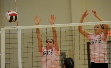 Emilie Ogas (left) and Ashley Young go up for a block in a match versus Rhodes (Tenn.) College. - Photo by Morris Abernathy