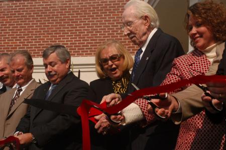 Carl Grant cuts the ribbon at the dedication of the Carl Grant Events Center. - Photo by Angela Abbamonte