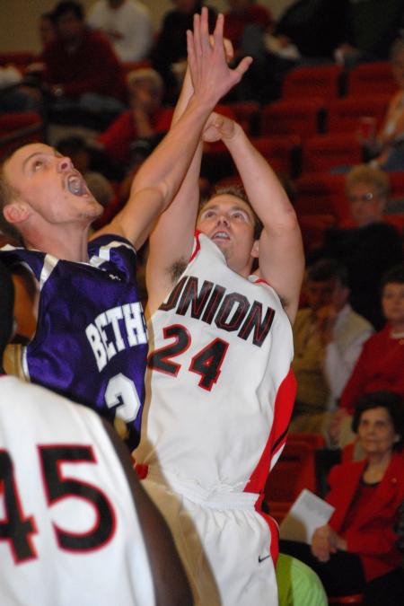 Junior Matt Neaville shoots over the hand of a Bethel (Tenn.) College defender. - Photo by Morris Abernathy