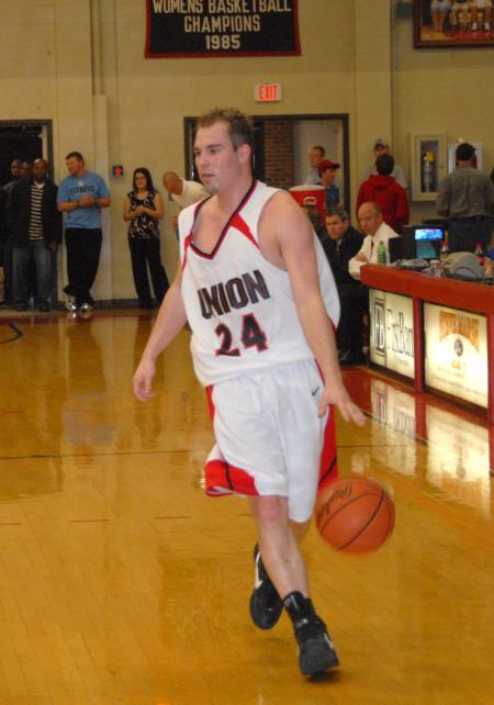 Matt Neaville, junior, brings the ball down the floor. - Photo by Morris Abernathy