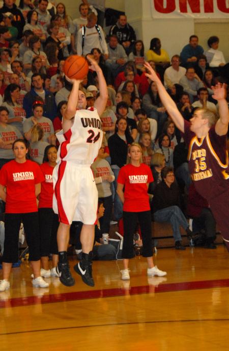 Junior guard Matt Neaville shoots a three-pointer over a Freed-Hardeman (Tenn.) University defender. - Photo by Morris Abernathy