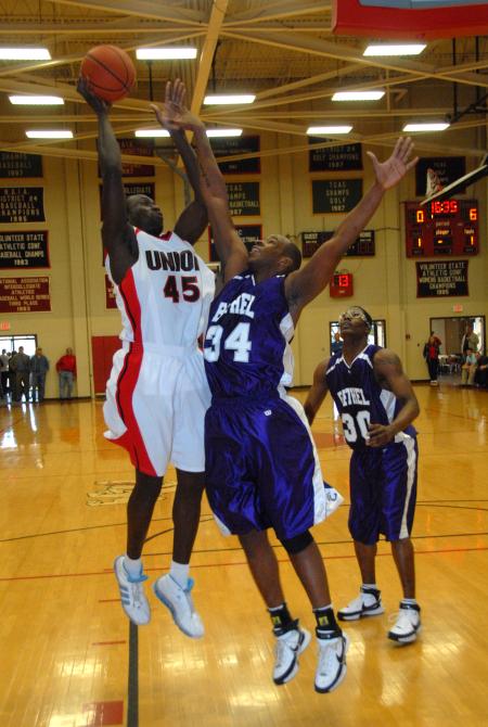 Union center Roland Banhoro (45) shoots over the defender from Bethel (Tenn.) College. - Photo by Morris Abernathy