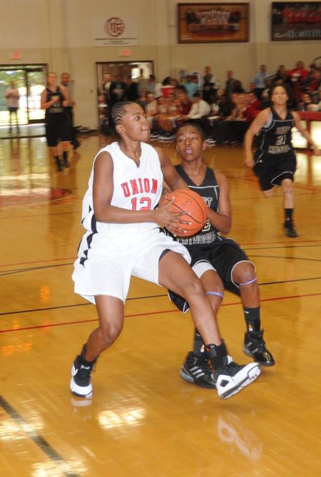 Union's Christina Ray (12) drives past a defender for the layup. - Photo by Morris Abernathy