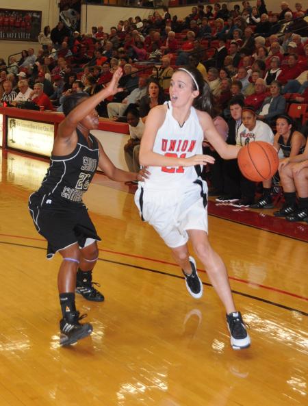 Lyndsay Flynn looks inside as she brings the ball moves the ball toward the basket. - Photo by Morris Abernathy