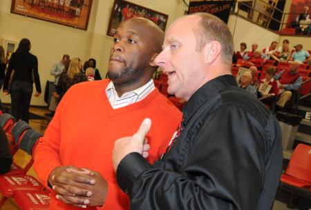 Union head coach Ralph Turner (right) talks with former player and Graduate Assistant Coach Chima Abakwue (left) prior to the start of Union's Homecoming game versus Robert Morris (Ill.) College. - Photo by Morris Abernathy