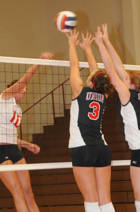 Heather Lieberman (left) and Anna Sims go up together for a block. - Photo by Morris Abernathy