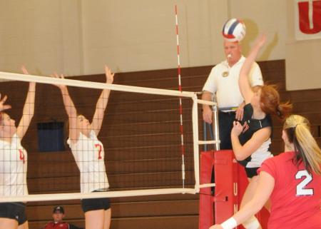 Anna Sims hits the ball over net in a match versus Lyon College in the TranSouth Conference Tournament. - Photo by Morris Abernathy