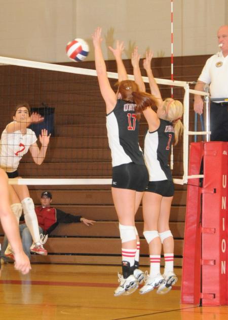 Anna Sims (left) and Katie Adams go up for a block. - Photo by Morris Abernathy