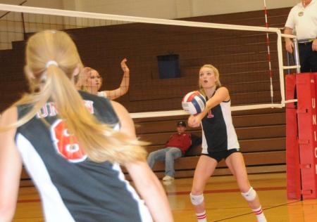 Katie Adams attempts to set Amanda Hutchison Coyle for an attack. - Photo by Morris Abernathy