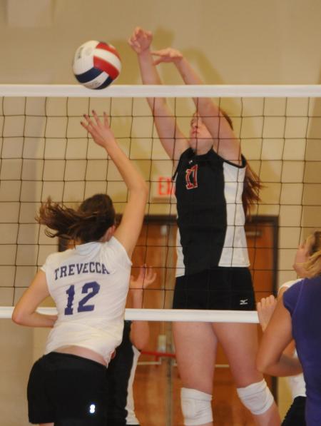 Anna Sims blocks the ball back down for a point during the championship match of the TranSouth Conference Tournament. - Photo by Morris Abernathy