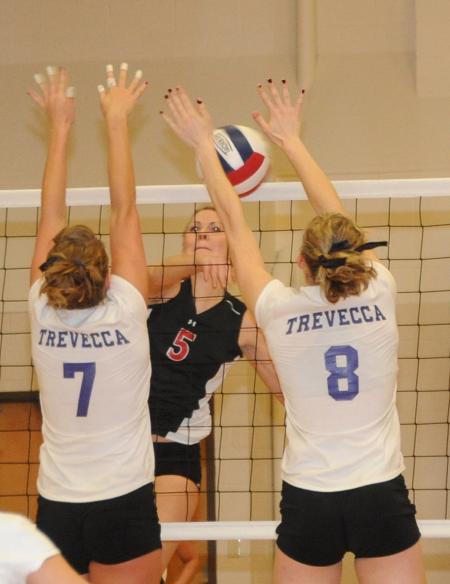 Ashley Young kills the ball into two blockers for a point in the championship match of the TranSouth Conference Tournament. - Photo by Morris Abernathy