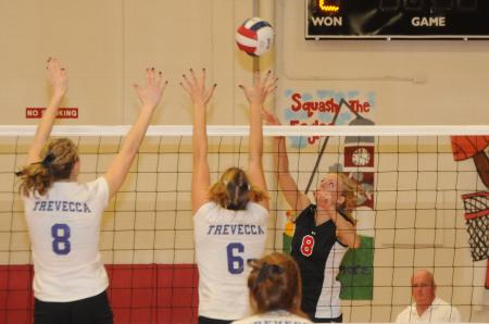 Amanda Hutchison Coyle goes up for a hit over two Trevecca blockers during the championship match of the TranSouth Conference Tournament. - Photo by Morris Abernathy