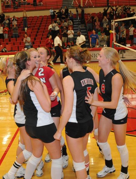 The Union volleyball players celebrate following the final point, earning them the conference tournament title. - Photo by Morris Abernathy