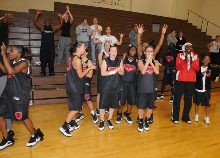 The Union Lady Bulldog basketball team celebrates the volleyball team's win in the TranSouth Tournament championship match. - Photo by Morris Abernathy