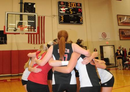 The Union volleyball team huddles after their game-winning point clinches the 2008 TranSouth Conference Tournament Title. - Photo by Morris Abernathy