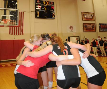 The Union volleyball team huddles together after their game-winning point clinches the 2008 TranSouth Conference Tournament Title. - Photo by Morris Abernathy